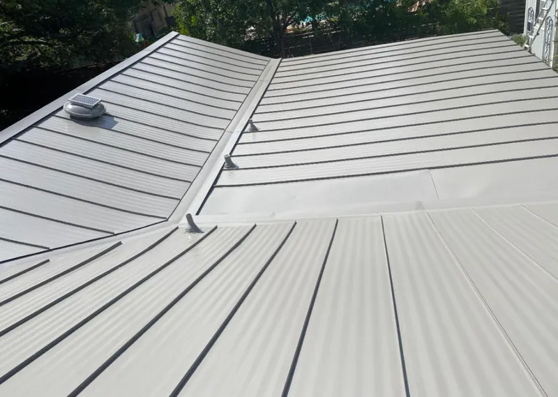 Solar attic fan installed on a metal roof for Roof Ventilation in Midland Park