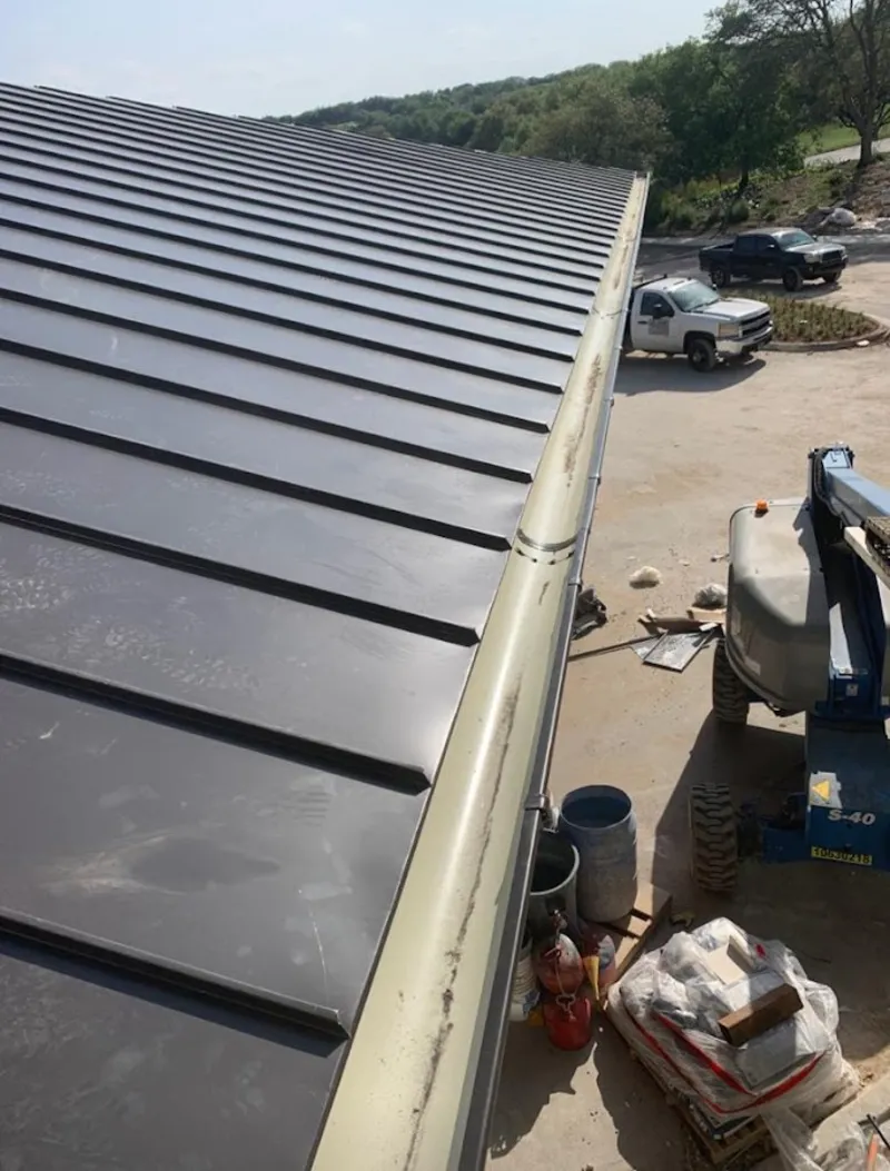 Standing seam panel and gutter detail on a metal roofing jobsite in Midland Park